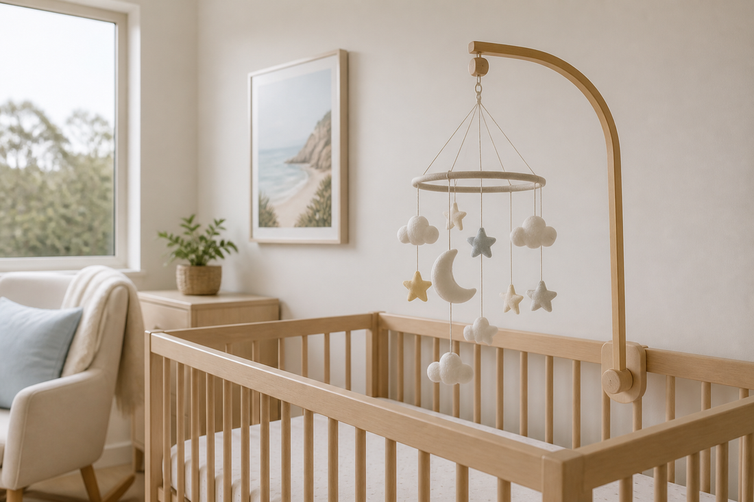 Modern Australian nursery with a baby mobile positioned above a clear timber cot