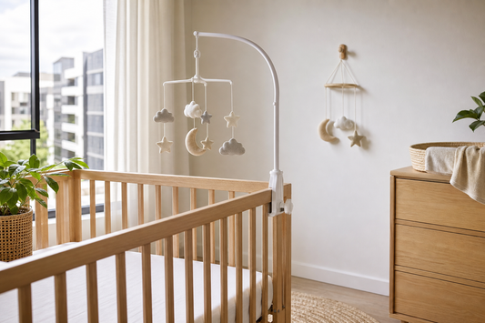 Australian rental nursery with a cot mobile hanger and wall hook comparison above a clear cot