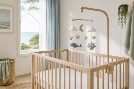 Coastal Australian nursery with a cot mobile above a clear timber cot
