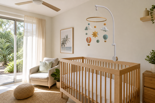 Soft modern Australian hot-weather nursery with a secure cot mobile above a clear cot
