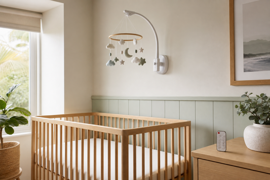 Modern Australian nursery with a secure cot mobile and remote control away from a clear cot