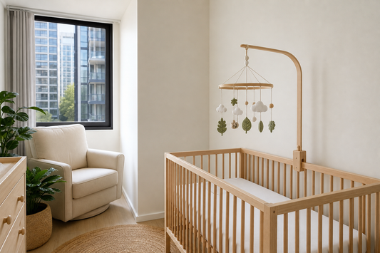 Soft modern Australian small nursery with a secure cot mobile above a clear cot