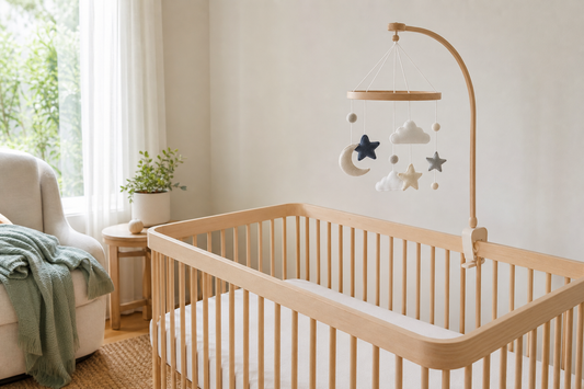 Soft modern Australian nursery with a secure cot mobile above a clear cot for a 0-3 month baby